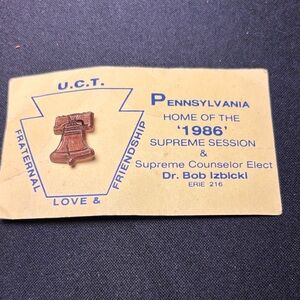 Political advertisement from 1986 with a Liberty Bell Pin marked Lewtan USA.